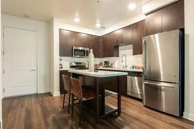 a kitchen with a refrigerator and a table and chairs at Cozy and Calm Retreat in Heart of Glendale in Glendale