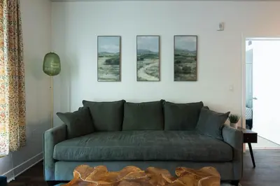 a living room with a couch and four pictures on the wall at Cozy and Calm Retreat in Heart of Glendale in Glendale