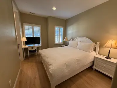 a bedroom with a bed and a desk and a television at Shopping at Arcadia Mall, Homes, School District, Comfortable Home on Huntington Road in Arcadia