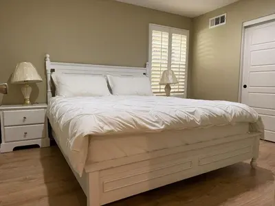 a bedroom with a large white bed and a window at Shopping at Arcadia Mall, Homes, School District, Comfortable Home on Huntington Road in Arcadia