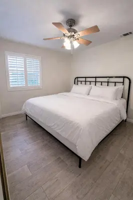 a bedroom with a bed with a ceiling fan at Luxury 4 Bedroom Home Pool Big Yard San Bernardino in San Bernardino