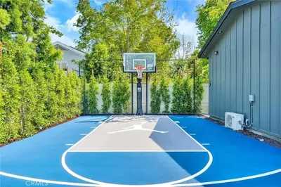 a basketball hoop on a blue basketball court at Studio City Luxury 6BR Home with Pool and Theatre in Los Angeles