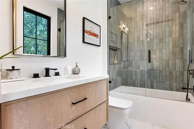 a bathroom with a sink and a toilet and a shower at Studio City Luxury 6BR Home with Pool and Theatre in Los Angeles