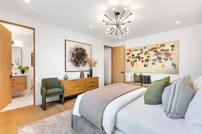 a bedroom with a bed and a desk and a chair at Studio City Luxury 6BR Home with Pool and Theatre in Los Angeles