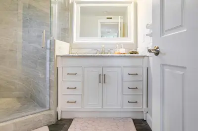 a white bathroom with a sink and a shower at Cozy 1BR Guest House with Mountain View in Simi Valley in Simi Valley