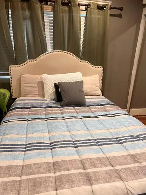 a bed with a laptop sitting on top of it at The Perfect studio in Riverside