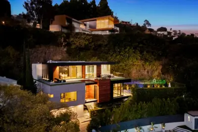 a house on the side of a hill at night at Belfast Estate in Los Angeles