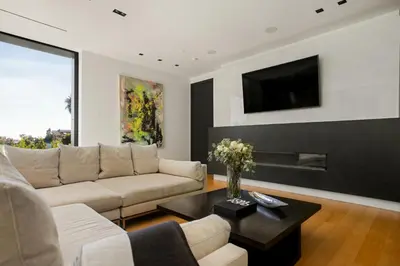 a living room with a couch and a tv at Belfast Estate in Los Angeles