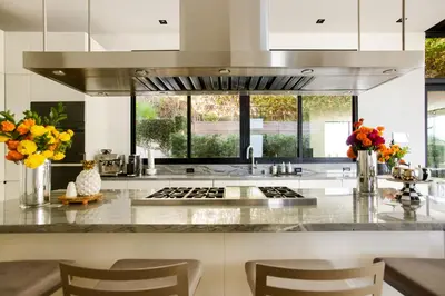 a kitchen with a counter with a sink and some flowers at Belfast Estate in Los Angeles