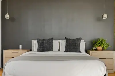 a bedroom with a large white bed with two night stands at Belfast Estate in Los Angeles
