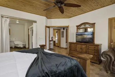 a bedroom with a bed and a ceiling fan at The Village Timber Lodge at Big Bear - Downtown Log Cabin Retreat in Big Bear Lake