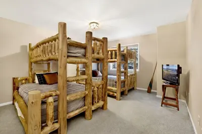 two bunk beds in a room with a television at Modern Relaxation at Castle Glen Gem Big Bear Lake in Big Bear Lake