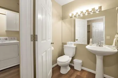 a white bathroom with a toilet and a sink at Modern Relaxation at Castle Glen Gem Big Bear Lake in Big Bear Lake