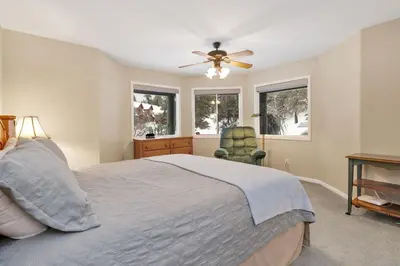 a bedroom with a bed and a ceiling fan at Modern Relaxation at Castle Glen Gem Big Bear Lake in Big Bear Lake