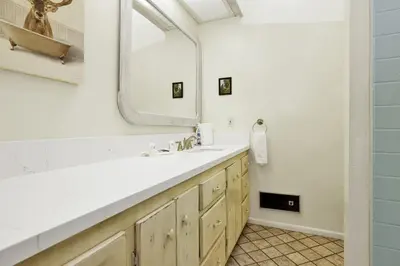 a bathroom with a sink and a mirror at Pleasant Pause Family Retreat in Big Bear Lake in Fawnskin