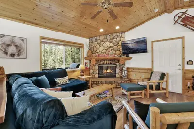 a living room with a couch and a fireplace at Lookout Lodge Family Chalet at Big Bear w/ Games in Big Bear City
