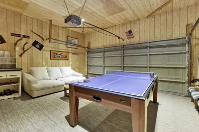 a living room with a ping pong table in it at Pines & Needles Mountain Retreat by Big Bear Vacations in Big Bear Lake