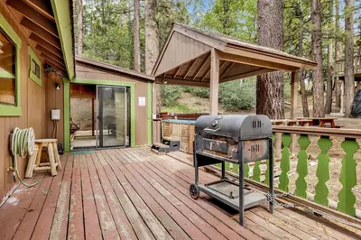 a grill on a deck of a house at Pines & Needles Mountain Retreat by Big Bear Vacations in Big Bear Lake
