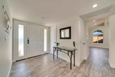 a hallway with a table in a house at Incredible View, Huge Pool & Basketball! in Tarzana