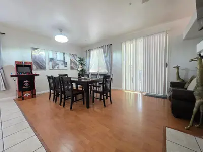 a dining room and living room with a table and chairs at Newly Listed Family Friendly Fontana House in Fontana