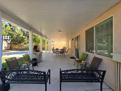 a porch with two benches and a table and chairs at Newly Listed Family Friendly Fontana House in Fontana