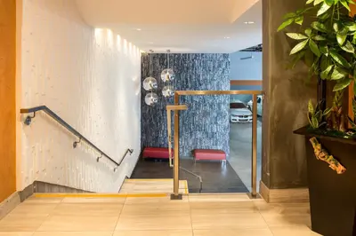 a hallway with a staircase with a blue curtain at Hotel Aventura in Los Angeles
