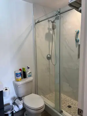 a bathroom with a toilet and a glass shower at Luxury guest suite in Los Angeles in North Hills
