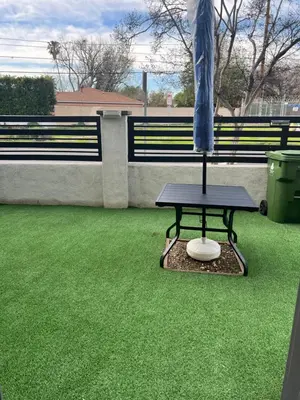 a table with an umbrella on top of grass at Luxury guest suite in Los Angeles in North Hills