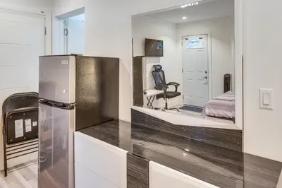 a kitchen with a stainless steel refrigerator and a bedroom at Luxury guest suite in Los Angeles in North Hills