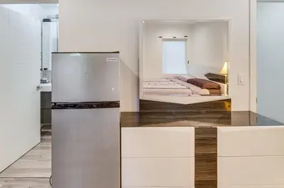 a kitchen with a refrigerator and a bed at Luxury guest suite in Los Angeles in North Hills