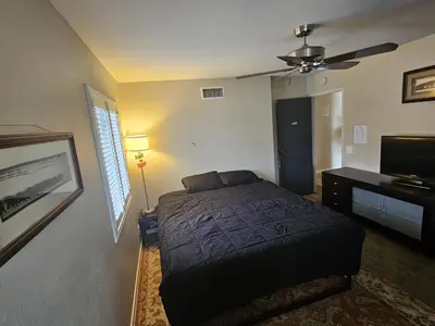 a bedroom with a bed and a ceiling fan at Santa Ana Vibes in Santa Ana