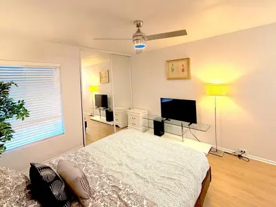 a bedroom with a bed and a flat screen tv at Great 2 Bedroom and 2 Bathroom Apartment in Marina in Los Angeles