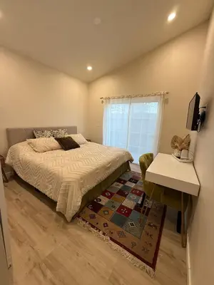 a bedroom with a bed and a table and a window at Perfect and relaxing Couple retreat in the heart of Los Angeles in Los Angeles