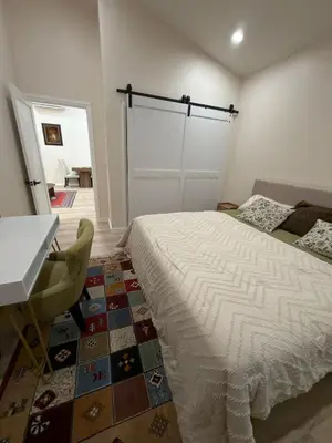 a bedroom with a bed and a table and a desk at Perfect and relaxing Couple retreat in the heart of Los Angeles in Los Angeles