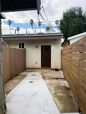 a house with a garage with a fence at Perfect and relaxing Couple retreat in the heart of Los Angeles in Los Angeles