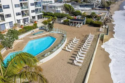 an aerial view of a swimming pool and beach at Aquareve in Malibu Beach