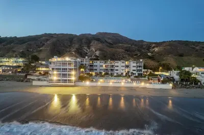 a hotel on the beach at night at Aquareve in Malibu Beach