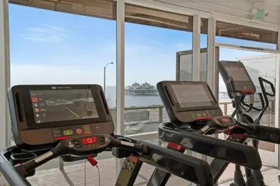 a gym with two exercise bikes with a view of the ocean at Aquareve in Malibu Beach