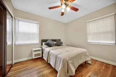 a bedroom with a bed and a ceiling fan at Luxury Cozy 2BR 1BA near LAX, LMU, SoFi Stadium, Beach in Los Angeles