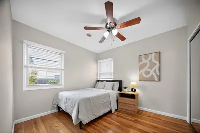 a bedroom with a bed and a ceiling fan at Cozy Modern 2BR 1BA near LAX, LMU, SoFi Stadium and the Beach in Los Angeles
