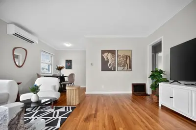 a living room with a television and a table at Cozy Modern 2BR 1BA near LAX, LMU, SoFi Stadium and the Beach in Los Angeles
