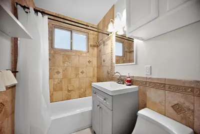 a bathroom with a sink and a toilet and a tub at Stylish LAX Area 2BR 1BA by LMU, SoFi Stadium & Coastal Beaches in Los Angeles