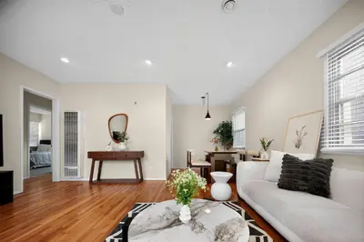a living room with a white couch and a table at Stylish LAX Area 2BR 1BA by LMU, SoFi Stadium & Coastal Beaches in Los Angeles