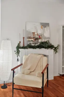 a living room with a fireplace with a christmas mantle at Cozy Comfort Stylish 2BR 1BA near LAX, LMU, SoFi Stadium & Beaches in Los Angeles