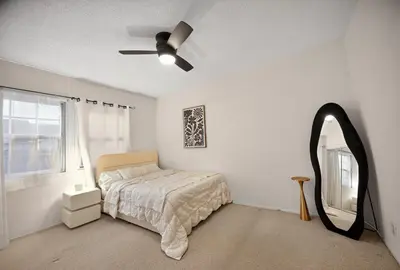 a bedroom with a bed and a mirror and a ceiling fan at Cozy Comfort Stylish 2BR 1BA near LAX, LMU, SoFi Stadium & Beaches in Los Angeles