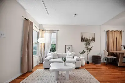 a white living room with a couch and a table at Cozy Comfort Stylish 2BR 1BA near LAX, LMU, SoFi Stadium & Beaches in Los Angeles