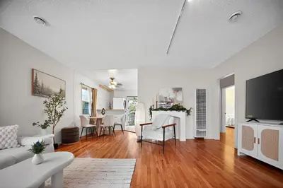 a living room with white furniture and a flat screen tv at Cozy Comfort Stylish 2BR 1BA near LAX, LMU, SoFi Stadium & Beaches in Los Angeles
