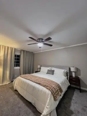 a bedroom with a bed with a ceiling fan at Bright & Spacious 5BR Modern Vacation Home - Near Disneyland & Beaches in Orange