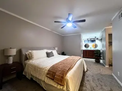 a bedroom with a bed and a ceiling fan at Bright & Spacious 5BR Modern Vacation Home - Near Disneyland & Beaches in Orange