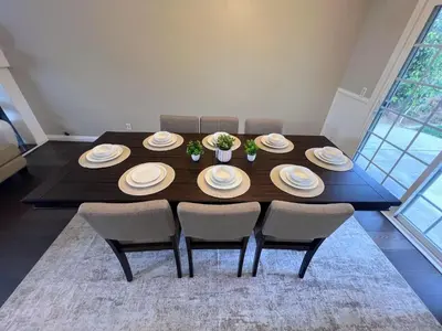 a dining room table with chairs and plates on it at Bright & Spacious 5BR Modern Vacation Home - Near Disneyland & Beaches in Orange